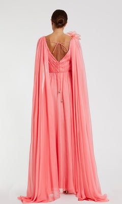 Facing away from the camera, a person showcases the Mac Duggal 68768 Long Formal Dress in pink chiffon, featuring dramatic floor-length cape sleeves and a tie detail at the back, set against a simple white backdrop.