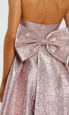 Close-up of the Mac Duggal 68805 Strapless Raspberry Formal Gown, showcasing its textured metallic fabric and a large structured bow at the waist—a stunning choice for any special occasion.