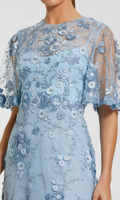 Model wearing the Mac Duggal 68810 Flutter-Sleeve Long Formal Dress in light blue, featuring short flutter sleeves, a sheer overlay, and floral embroidery; shown from shoulders to knees.