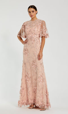 A woman stands against a white background wearing the Mac Duggal 68810 Flutter-Sleeve Long Formal Dress, a floor-length light pink lace gown with floral embroidery and short sheer flutter sleeves.