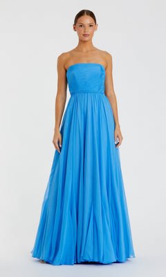 A woman stands facing forward, wearing the Mac Duggal 68847 Long Formal Dress. The strapless chiffon gown in vibrant turquoise features a fitted bodice and an elegant, flowing A-line skirt that gracefully reaches the floor.