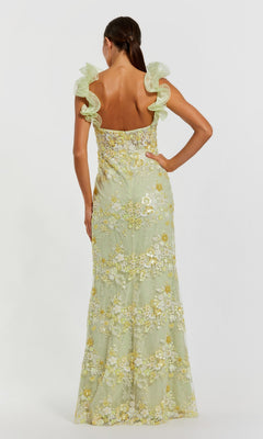 A woman with her back to the camera wears the Mac Duggal 68880, a long light green formal dress featuring floral embroidery and ruffled shoulder straps.