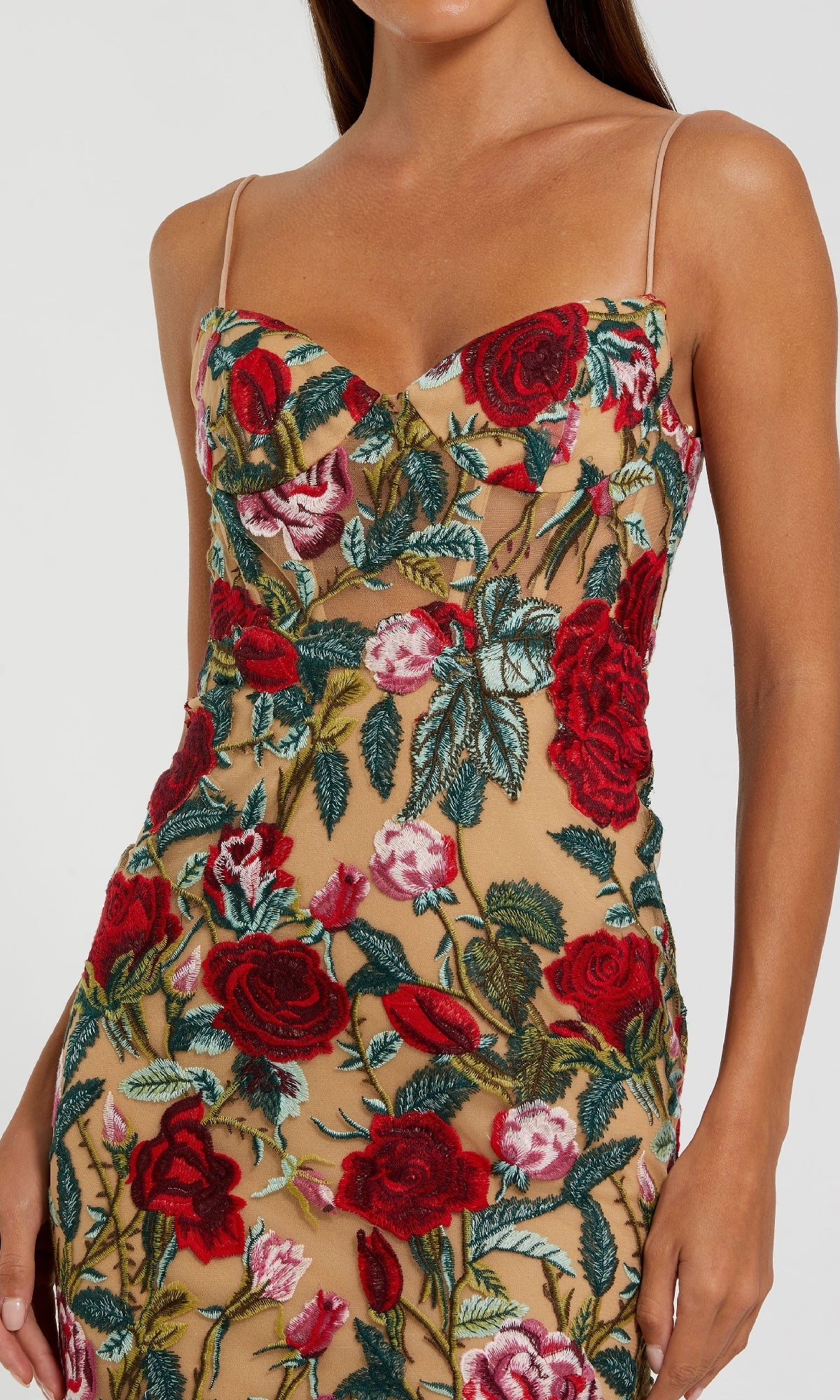 Woman in the Mac Duggal 68884 Long Floral-Lace Formal Dress—sleeveless and nude, with thin straps and embroidered red roses with green leaves.