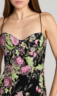 A woman in the Mac Duggal 68891 beaded long floral formal dress, featuring thin straps and pink-green embroidered sequins, radiates classic elegance.