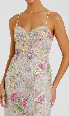A woman in the Mac Duggal 68891 long formal dress, featuring sleeveless design, thin straps, pastel floral embroidery, and sequin embellishments.