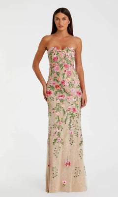 A woman models the Mac Duggal 68894 Long Formal Dress in Nude Multi—a strapless, floor-length gown embellished with pink and green floral embroidery—standing against a plain white background.