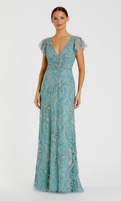 A woman wearing the Mac Duggal 68914 Long Formal Dress in seafoam, featuring short sheer sleeves, a deep V-neckline, and intricate shimmering beadwork. The floor-length gown exudes timeless sophistication and elegance against a plain light background.
