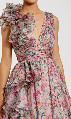 A woman wears the Mac Duggal 68947 Floral-Print Long Formal Dress, featuring a sleeveless deep V-neck, ruffled shoulders, and a pleated waist—ideal as a chiffon prom or formal gown.
