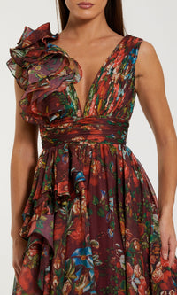 A woman wears the Mac Duggal 68947, a floral-print long formal dress with a sleeveless deep V-neckline and layered ruffles on one shoulder—an ideal chiffon prom gown.