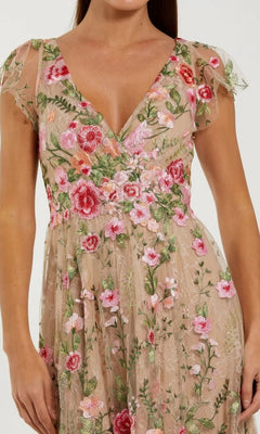 Woman wearing a beige lace midi wedding guest dress with pink, red, and green floral embroidery; the dress features short sleeves and a flattering V-neckline.