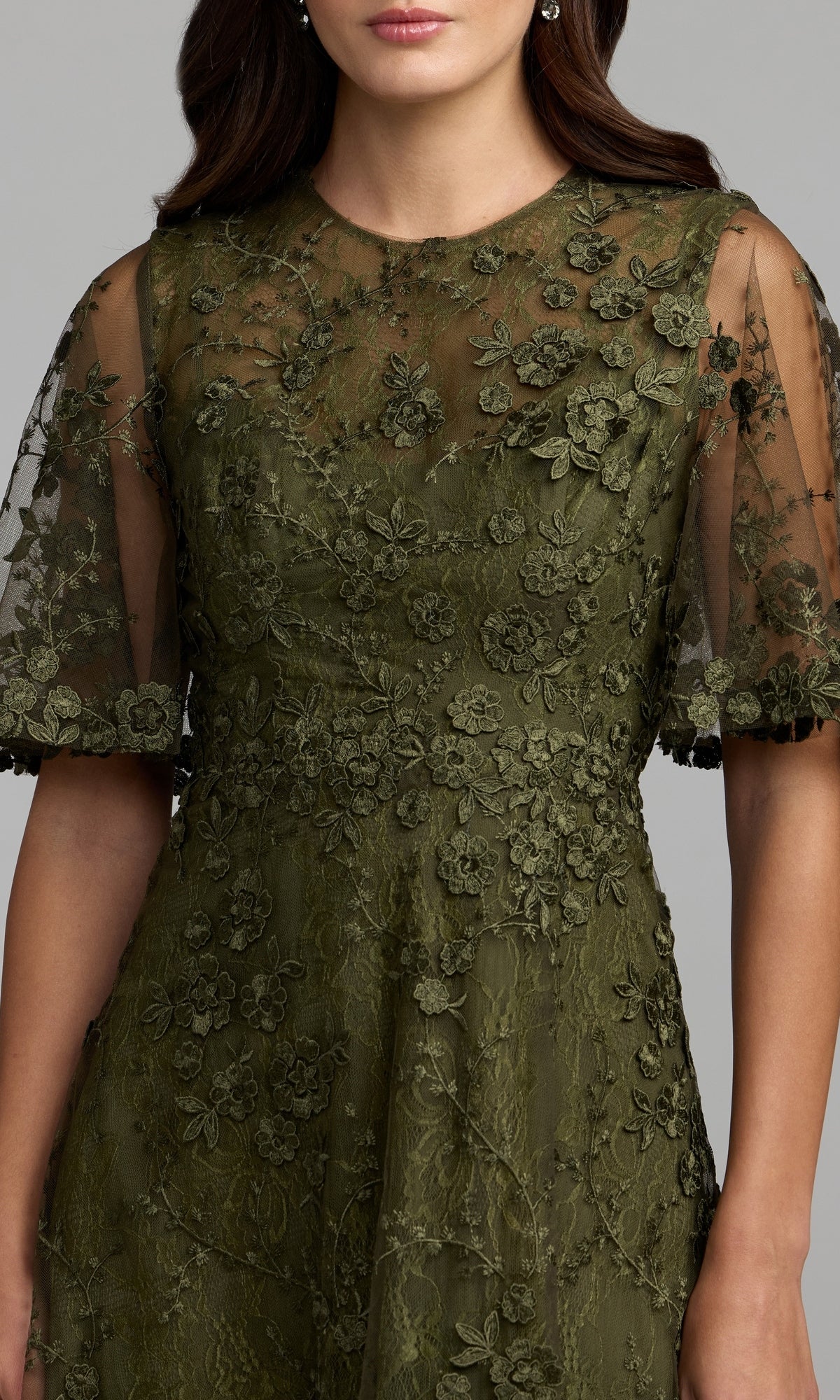 A woman wearing the Lace Midi Wedding Guest Dress: Mac Duggal 69036 in olive green, featuring sheer short sleeves and delicate floral embroidery, photographed from shoulders to mid-thigh—a perfect choice for a wedding guest dress.