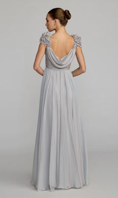 A woman stands against a plain background wearing the Long Formal Dress: Mac Duggal 69088, a light gray gown with an elegant A-line silhouette, draped back, ruffled short sleeves, and her hair styled in a neat bun.