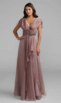A woman wearing the Long Formal Dress: Mac Duggal 69089 in mocha—a floor-length chiffon formal gown featuring ruffled accents, a V-neckline, cap sleeves with ties, and a crystal-embellished waistband—stands against a neutral gray background.