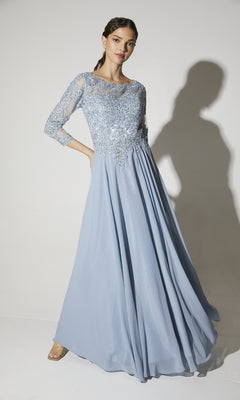 A woman poses gracefully against a white background in the Eureka 6909 long-sleeve formal dress, featuring a light blue lace bodice and delicate sleeves.