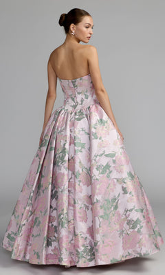 A woman is shown from the back against a plain gray background, wearing the Mac Duggal 69162 Long Formal Dress—a strapless pink ball gown with a full skirt and metallic floral print.