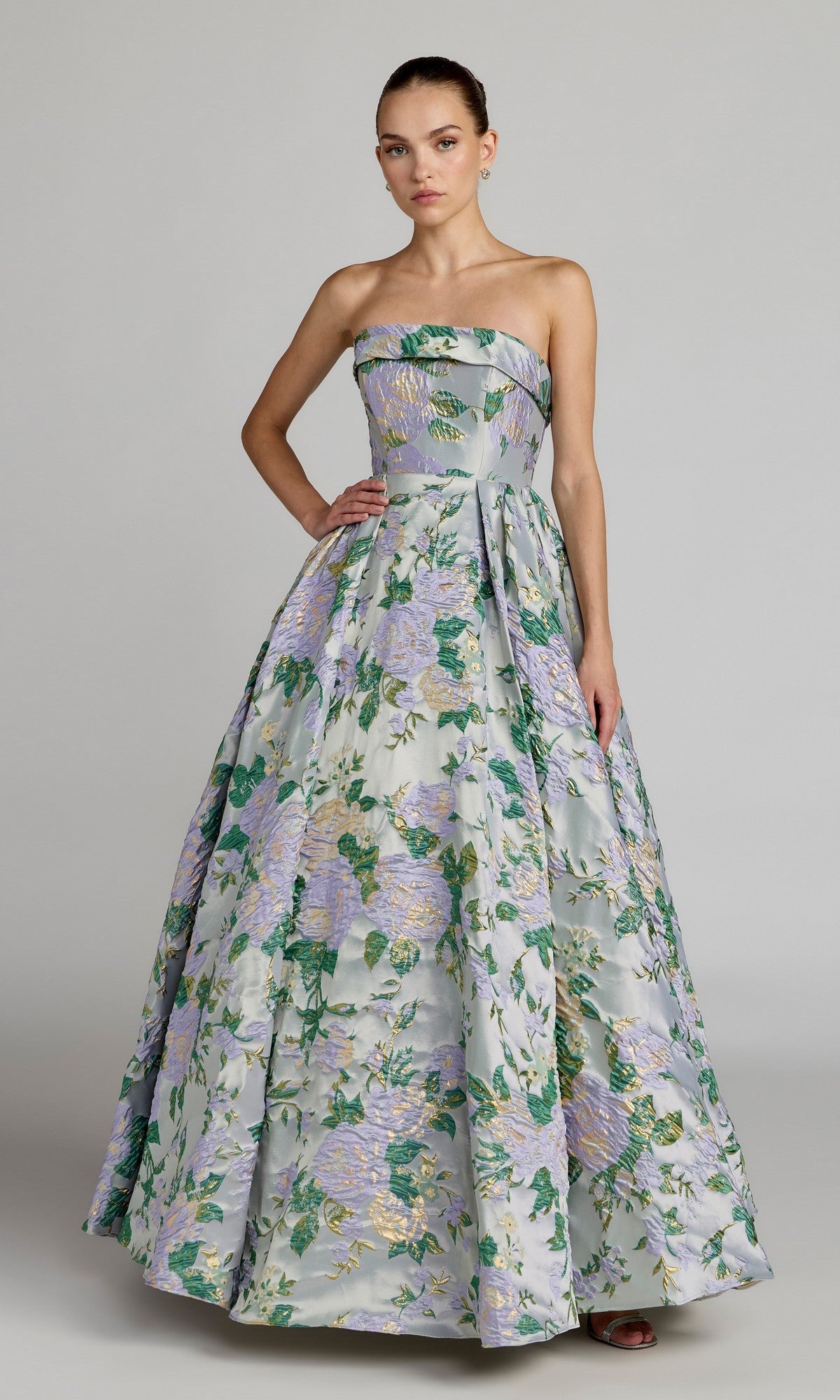 A woman wearing the Mac Duggal 69172 long formal dress in Lilac Multi stands against a plain gray background.