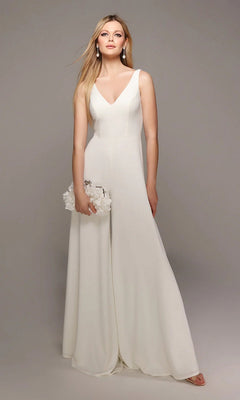 A woman models the Alyce 70021 long white jumpsuit in ivory, featuring wide-leg pants and a sleeveless design, holding a white clutch against a plain gray background.