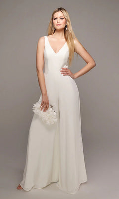 A woman wearing the Alyce 70021 Long White Jumpsuit with wide-leg pants holds a white floral clutch, standing against a plain background.