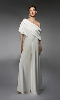 A woman poses in the Alyce 70072 long white jumpsuit in ivory with wide-leg pants and statement earrings, set against a plain gray background.