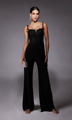 Woman wearing the Alyce 70073 Long Formal Jumpsuit in black, featuring a sleeveless design with sequin details, holding a silver clutch against a neutral background.