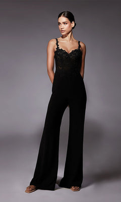 Woman wearing the Long Formal Jumpsuit: Alyce 70074, featuring lace trim and wide legs, stands against a plain gray background with her hands in her pockets.