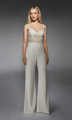 A woman poses in the Long Formal Jumpsuit: Alyce 70074, featuring a sheer lace bodice with floral embroidery, spaghetti straps, and wide-leg pants against a plain gray background.