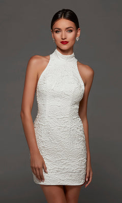 A woman wearing the Short White Party Dress: Alyce 70094 in Diamond White, a sleeveless mini dress with a high mock neckline and crafted from textured fabric, stands against a plain gray background.