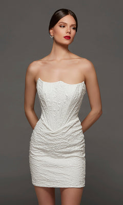 A woman models the Alyce 70095 short white party dress in diamond white, featuring a strapless jacquard design with a corset bodice and textured fabric, standing against a plain gray background with her hands behind her back.