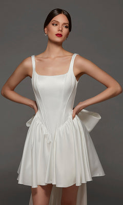 A woman models the Alyce 70103 Short White Party Dress in Diamond White, featuring a corset bodice, wide straps, and a flared skirt with a side bow detail—all elegantly framed by a chic square neckline.