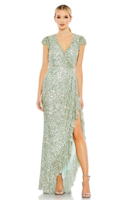 A woman in the Long Formal Dress 70113 by Mac Duggal—light green with sequins, V-neckline, cap sleeves, and a thigh-high slit—stands against a plain background.
