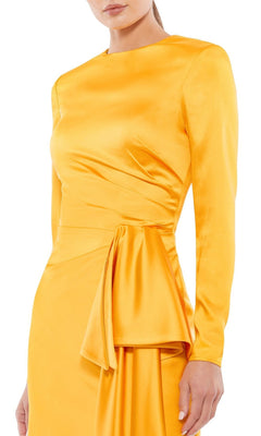A woman wears the Yellow Cocktail Party Dress 70152 by Mac Duggal, featuring marigold yellow fabric, long sleeves, a fitted waist, and draped hip detail.