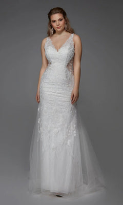 A woman wearing the Alyce 7017 Long White Dress in Diamond White, featuring a sleeveless lace design, V-neckline, sheer side panels, and a fitted silhouette, poses against a plain gray background.