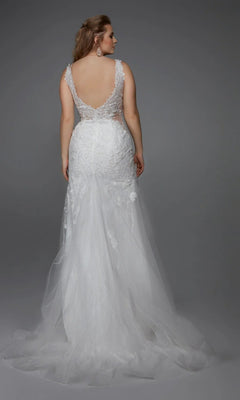 A woman models the Alyce 7017, a long white dress with a lace low back, elegant trumpet skirt, and flowing tulle train, standing against a plain gray background.