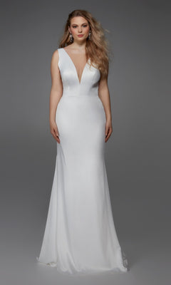A woman stands against a plain gray background wearing the Alyce 7019—a sleeveless, floor-length white satin dress with a deep V-neckline.