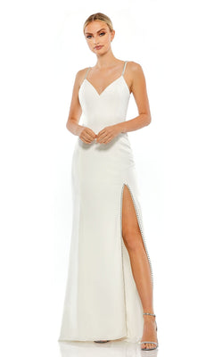 A woman models the Long Formal Dress 70220 by Mac Duggal, featuring a sleeveless white v-neck design with thin straps, beaded trim, and a thigh-high slit, standing against a plain white background.