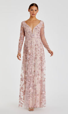 A woman stands facing forward in the Mac Duggal 70224 Long Sleeve Long Formal Dress—a light pink, embroidered maxi gown with floral details—set against a plain white background.