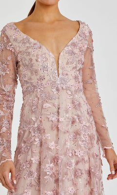A woman wearing the Mac Duggal 70224 long sleeve formal dress in light pink, featuring floral lace embroidery and a deep V-neckline.