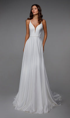 A woman stands against a plain gray background wearing the Alyce 7024, a sleeveless white satin long formal dress featuring a deep V-neckline and flowing A-line skirt.