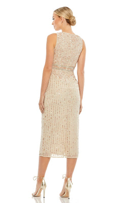 A woman faces away, wearing the Mac Duggal 70267 Beaded Midi Wedding-Guest Dress with gold heels. Her hair is in a low bun, and the background is plain white.