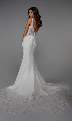 A woman faces away from the camera in the Alyce 7027 long white dress, featuring a backless design, sleeveless cut, lace embroidery, and a long train.
