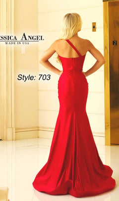 A woman with long blonde hair stands by an elevator in a bold red, fitted One-Shoulder Long Prom Dress: Jessica Angel 703—a stunning floor-length mermaid gown labeled "JESSICA ANGEL MADE IN USA.