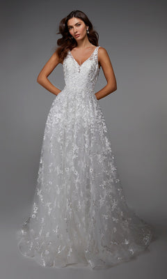 A woman models the Alyce 7037 long ivory dress featuring a sleeveless design, V-neckline, and floral lace details, set against a plain grey background.