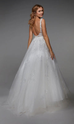 A woman, seen from behind, wears the sleeveless, backless Long White Dress: Alyce 7039 with delicate lace details, standing against a gray background.