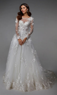 A woman stands against a plain gray background wearing the Alyce 7046 long ivory dress, featuring lace detailing, floral embroidery, sheer neckline, and long sleeves.