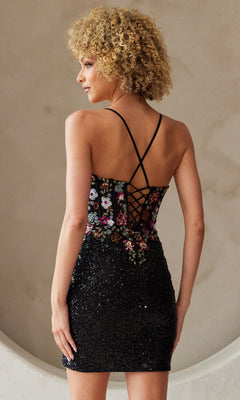 A woman stands with her back to the camera, wearing the Floral-Embroidered Short Sequin Hoco Dress 7054S, featuring a black sequin skirt, corset-style floral embroidered bodice, and crisscross straps.
