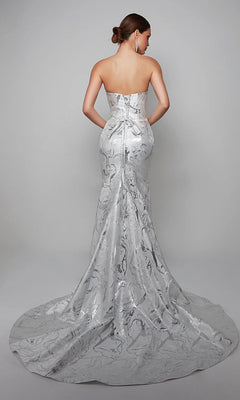 A woman faces away wearing the Alyce 7055, a long white strapless gown with a fitted bodice and flowing train—ideal for a mother-of-the-bride look against a plain backdrop.