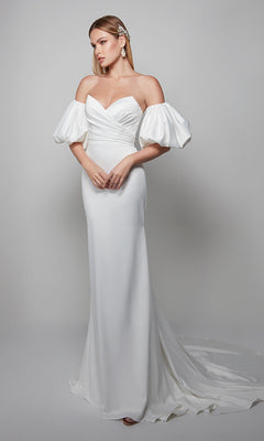 A woman models the Alyce 7056 long formal dress, featuring a white sweetheart neckline, off-the-shoulder puffed sleeves, fitted bodice, and a long train against a simple light background.