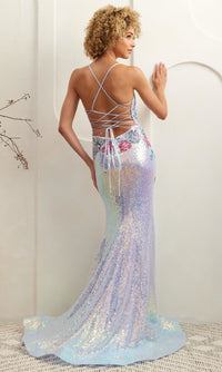Woman modeling the back of a light blue sequin evening gown with a strappy backless design, standing against a white wall.