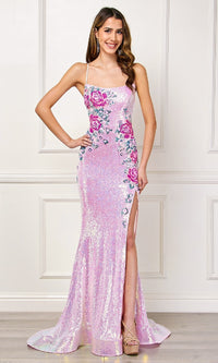 Woman wearing a pink evening gown with floral embellishments on a white background