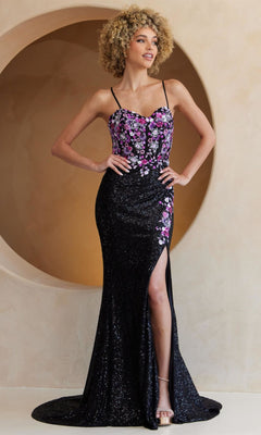 A woman poses before a circular wall feature in the Amelia Couture 7061 Multicolored Sequin Prom Gown, featuring a thigh-high slit and a fitted floral-patterned bodice with thin straps.